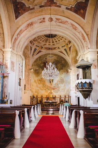 A vertical shot of the inside of a church decorated for a wedding ceremony
