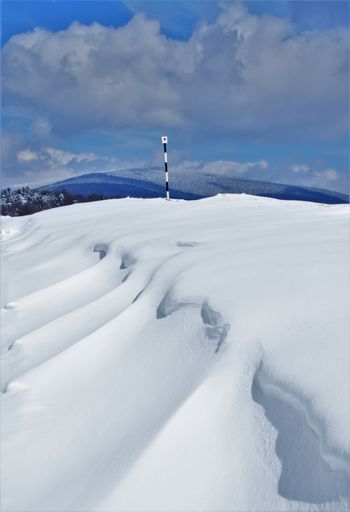 A vertical shot of a snowy mountain tourist route