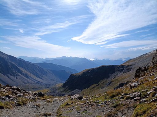 An aerial view of a steep and winding road snaking through a mountainous landscape