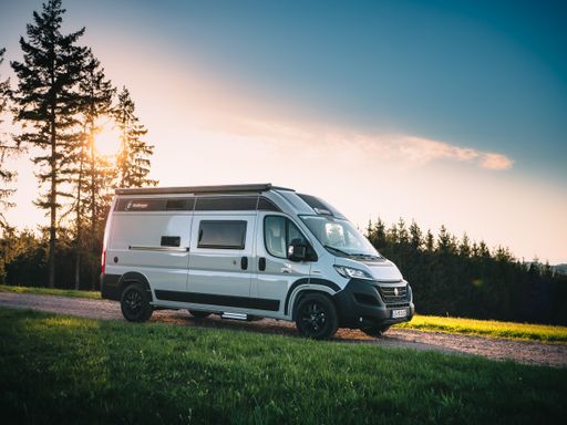 Traveling with a Campingcar in the nature surrounded by woods and mountains