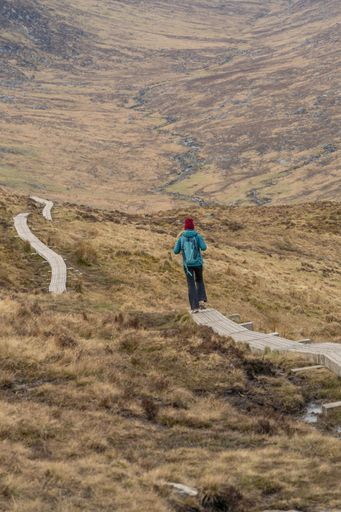 A beautiful shot of a hiker on the trail of the Sugar Loaf Mountain in Wickow, Ireland