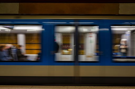 A modern subway train passing a subway station in Munich, Germany