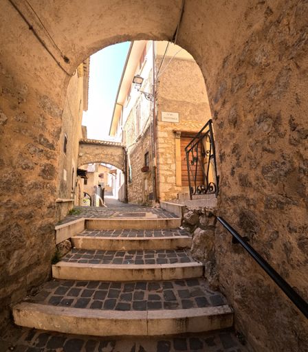 A narrow street among the old houses of Torre Cajetani, a medieval town in the province of Frosinone.