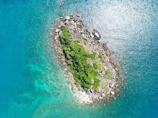 A drone view of the Fitzroy Island surrounded by the sea on a sunny day in Australia