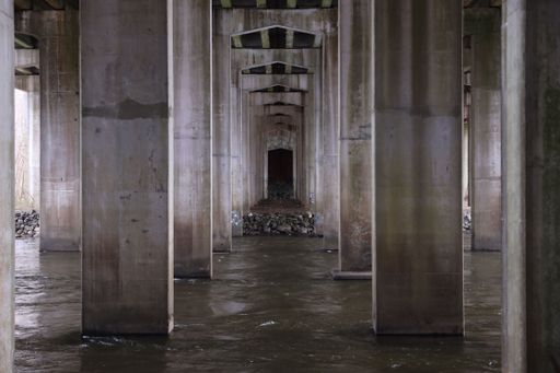 A scenic view of an abandoned corridor featuring an array of columns