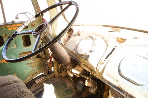 Interior of a driver's cab of an old abandoned and damaged vintage truck. Vehicle interior.