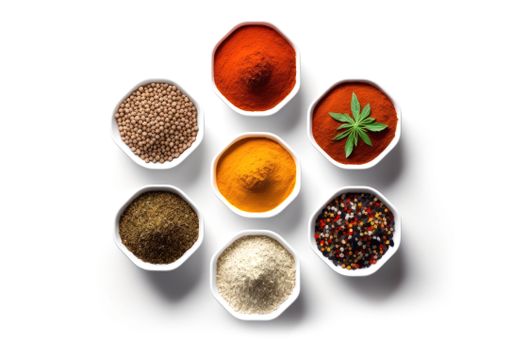 A colorful array of spices lined up in a row on a white surface