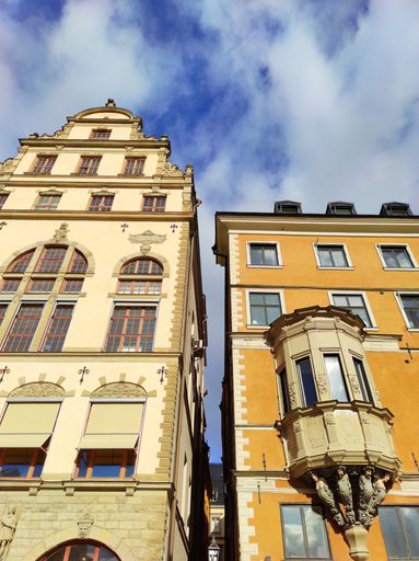 A vertical low angle shot of the colorful old buildings captured in Stockholm, Sweden