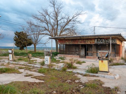 An old vandalized and dilapidated service station from the 60s