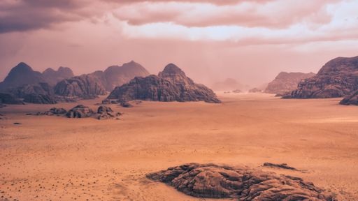 Storm and rain clouds over the desert landscape of Wadi Rum in Jordan. Panoramic shot 16:9 aspect ratio.