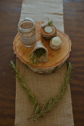 A selective focus shot of eco-style wedding decorations on a small wooden stump