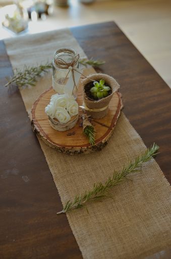 A selective focus shot of eco-style wedding decorations on a small wooden stump