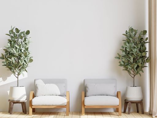 A 3D illustration of a home interior featured two pastel armchairs and plants