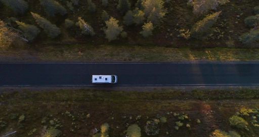 Aerial view of a camper, wild camping on a side of road - overhead, drone shot