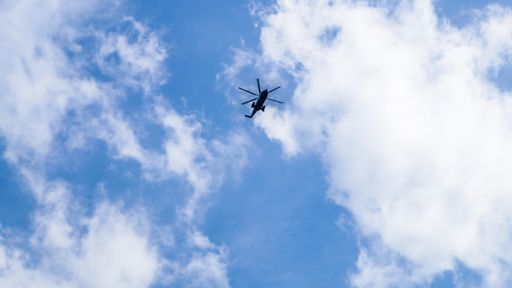 A low angle shot of a helicopter in the sky