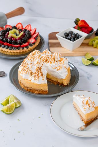 A vertical shot of a yummy lemon cake decorated with whipped cream.