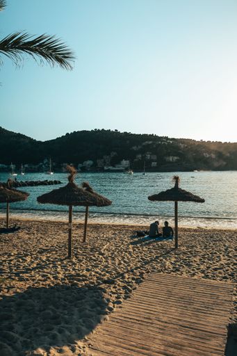 A picturesque beach scene with a variety of beach chairs and umbrellas scattered on the sand