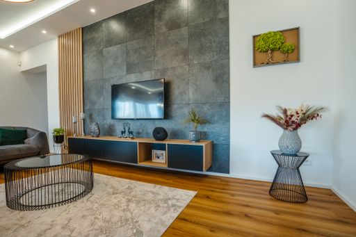 A flat-screen television mounted on top of an entertainment center in a domestic living room setting