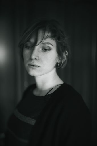 A vertical grayscale shot of a beautiful Italian Caucasian woman with short hair