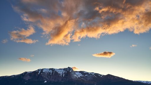 The scenic snowy hills in Vossevangen, Voss, Norway under the cloudy sky