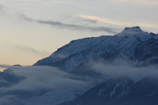 A mesmerizing view of beautiful snow-capped mountains under a cloudy sky