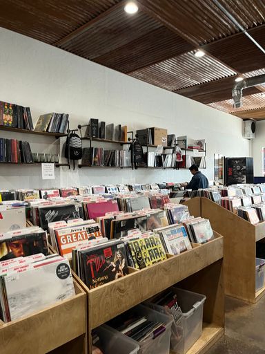 A modern music store with an array of records on the shelves