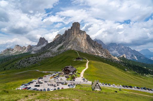 An aerial view of houses on green hills of Seceda, South Tyrol, Dolomites, Italy