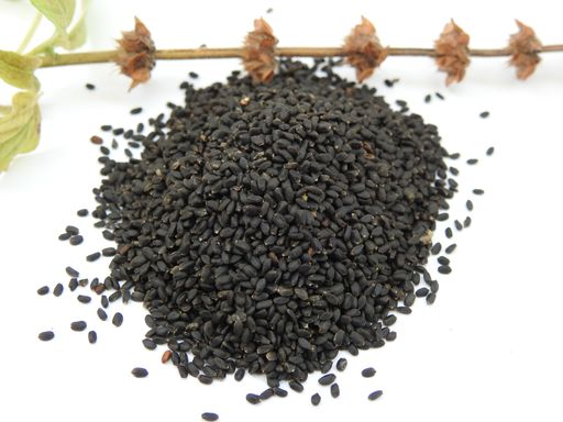 A Closeup of Chia or Salvia Hispanica seeds with flowers on white background