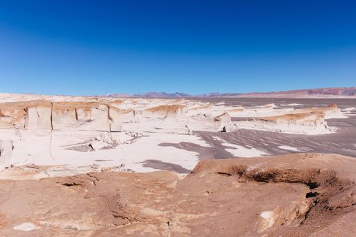 A stunning barren area in a white desert with volcanic rock formations in Campo De Piedra Pomez