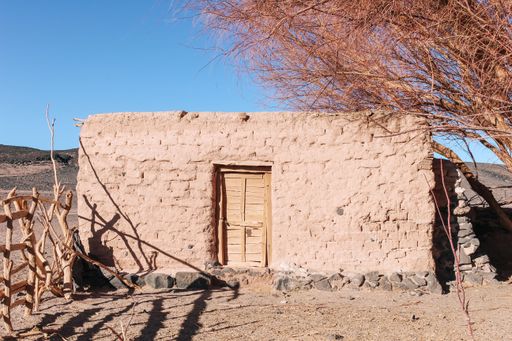 The traditional old rural construction made with adobe and volcanic stones at Carachi Pampa Volcano