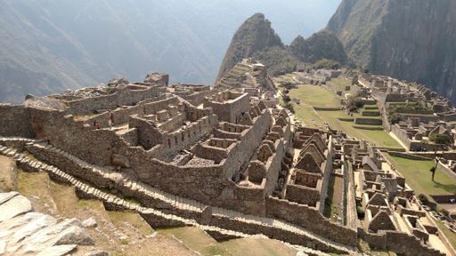 An aerial view of the old Machu Picchu citadel located in the Eastern Cordillera on a sunny day