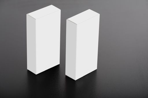 A closeup of white blank medical pill packs with space for text on the table