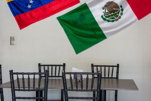 A restaurant with tables for dinners with the flags of Mexico and Venezuela - multiethnic cafe, latin american food