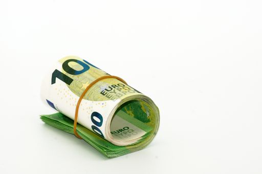 A closeup shot of rolled Euro banknotes isolated on a white background