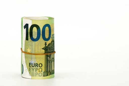 A closeup shot of rolled Euro banknotes isolated on a white background