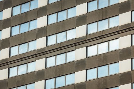 A low angle shot of a high-rise building in a glass facade