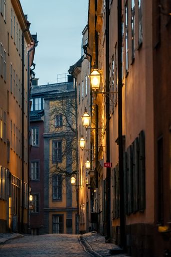 A picturesque cobblestone street illuminated by street lamps. Gamla stan, Stockholm, Sweden.