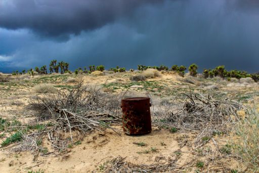 A rusty tin can in the middle of a deserted field, used for target practice