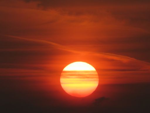 A closeup shot of the beautiful sun going down on an orange-red sky