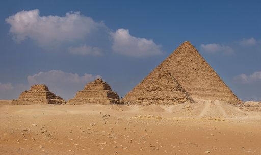 A stunning view of the pyramids of Giza under a cloudy sky