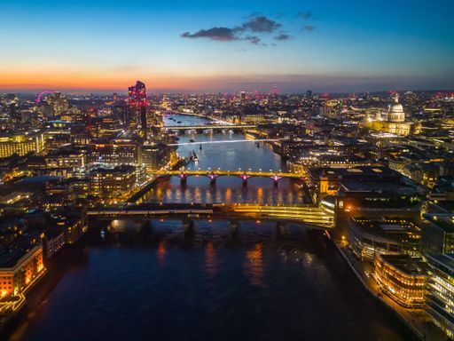 An aerial view of the London skyline illuminated during blue hour, United Kingdom.