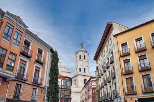 The streets in the historic center of Valladolid with the bell tower of the cathedral on background