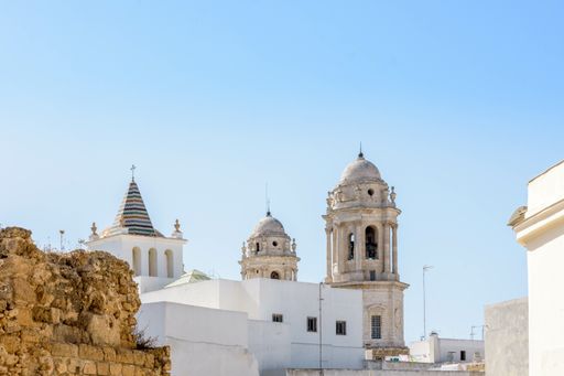 A low-angle shot of a religious Cathedral in Cadiz, Andalusia, Spain against the clear blue sky