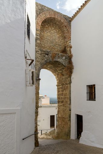 A vertical shot of a stone arch in Vejer de la Frontera, Spain