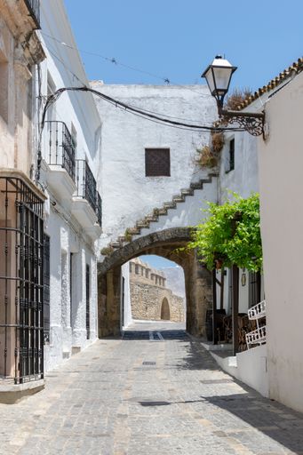 A narrow asphalt path with white buildings in Medina-Sidonia, Spanish village Vejer de la Frontera