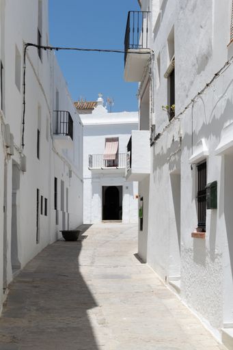 A narrow asphalt path with white buildings in Medina-Sidonia, Spanish village Vejer de la Frontera