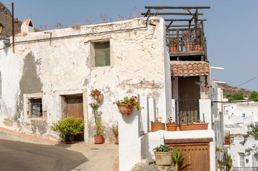 The old houses of Lucainena de las Torres under the sunlight and a blue sky in Spain