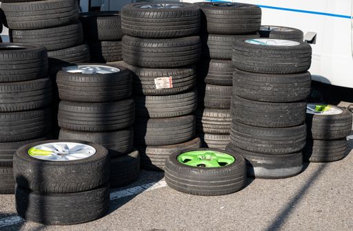A pile of mounted wheels, tires and rims from a drift racing team
