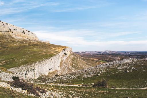 A beautiful view of green mountains and gorges against the cloudy sky