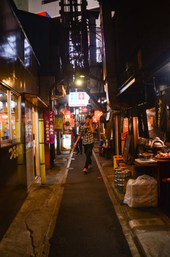 Night walk through the narrow Tokyo streets of Shinjuku district and its small restaurants